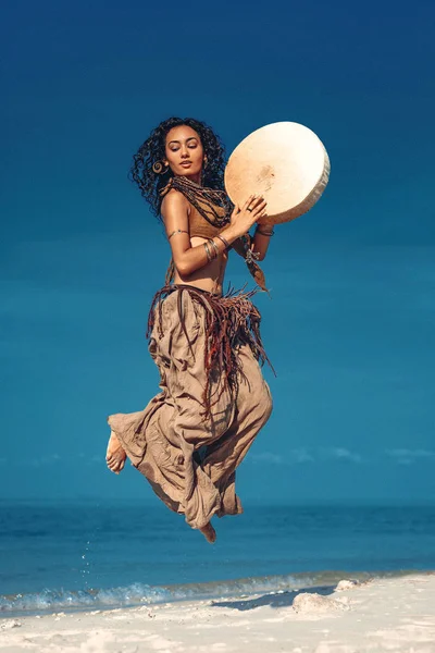 beautiful-young-woman-playing-ethnical-shamanic-drumming